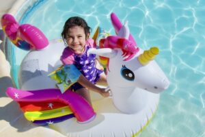 Edie smiling on a unicorn